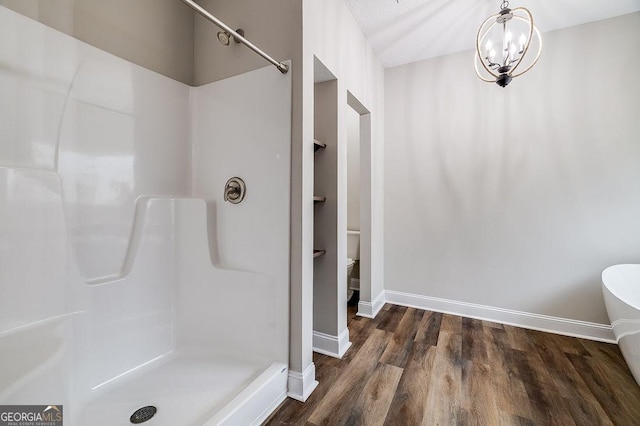 bathroom with a shower, wood-type flooring, a textured ceiling, and a chandelier