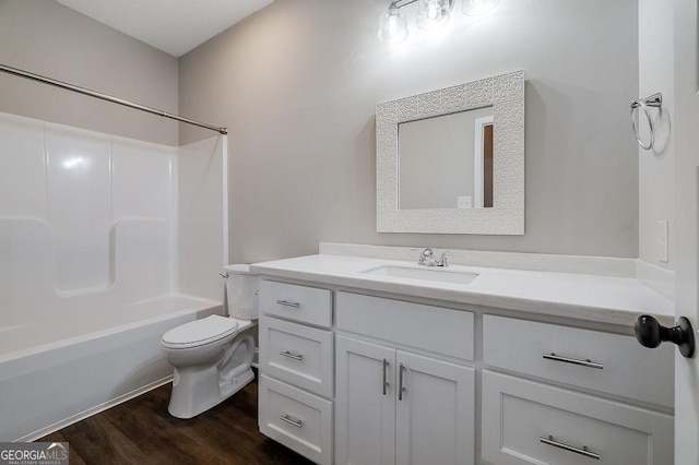 full bathroom featuring hardwood / wood-style flooring, vanity, toilet, and tub / shower combination