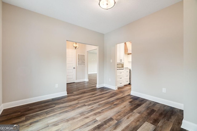 unfurnished bedroom featuring dark hardwood / wood-style floors