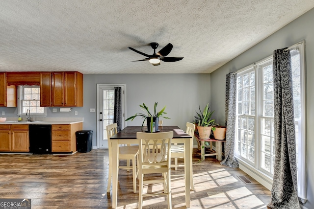 dining space with light wood-type flooring, plenty of natural light, ceiling fan, and sink