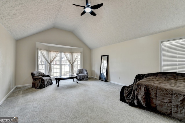 bedroom with carpet flooring, a textured ceiling, ceiling fan, and lofted ceiling