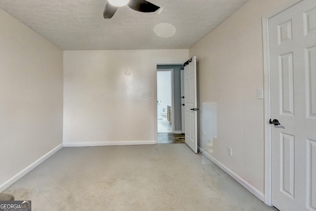 carpeted empty room with a textured ceiling and ceiling fan