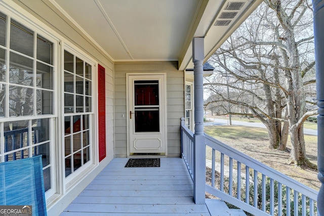 view of exterior entry featuring a porch