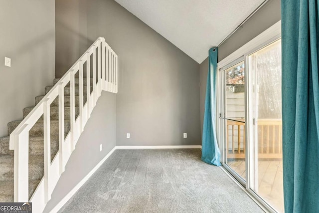 interior space featuring carpet flooring and vaulted ceiling