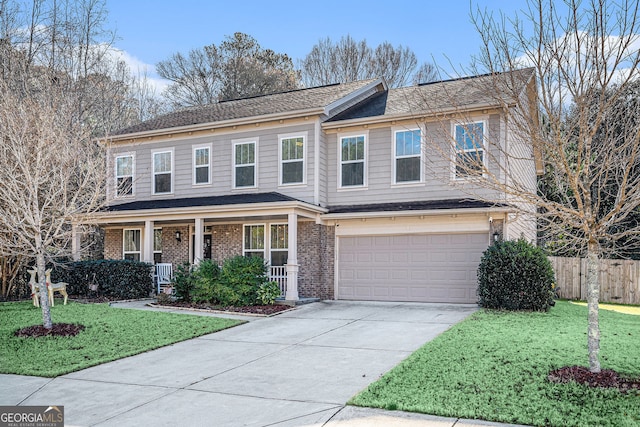 view of front of home featuring a porch, a garage, and a front yard