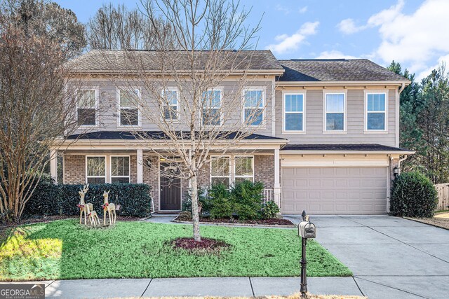 view of front of house with a front yard and a garage