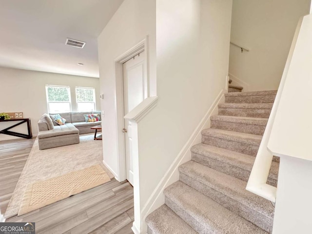 stairs featuring wood-type flooring