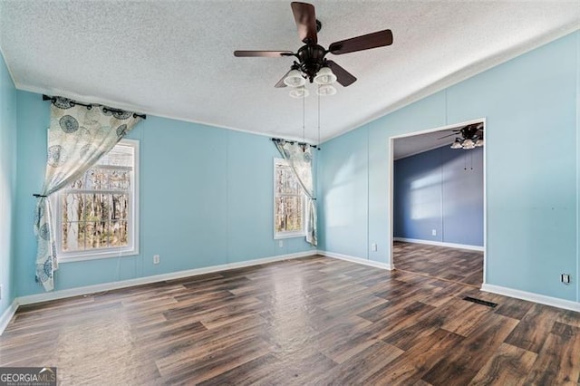 spare room with a textured ceiling, vaulted ceiling, ceiling fan, and dark wood-type flooring