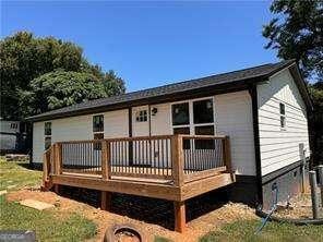 back of house featuring a wooden deck