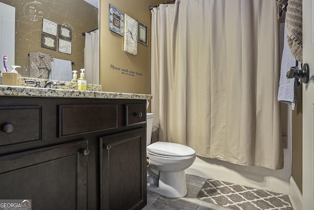 bathroom with tile patterned floors, vanity, and toilet