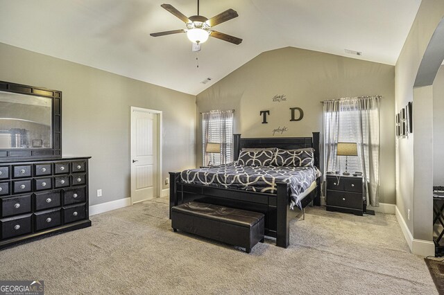 carpeted bedroom with multiple windows, ceiling fan, and lofted ceiling