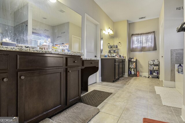 bathroom featuring tile patterned floors and vanity