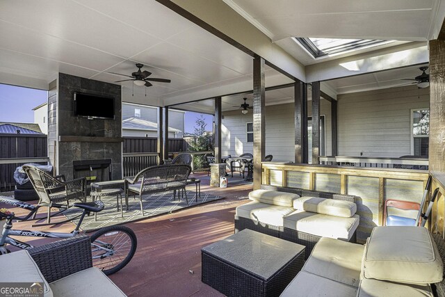 view of patio / terrace featuring ceiling fan and an outdoor stone fireplace