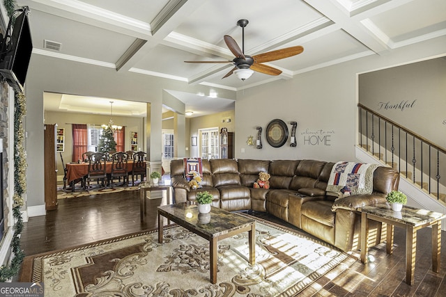 living room featuring beam ceiling, ceiling fan with notable chandelier, coffered ceiling, and hardwood / wood-style flooring