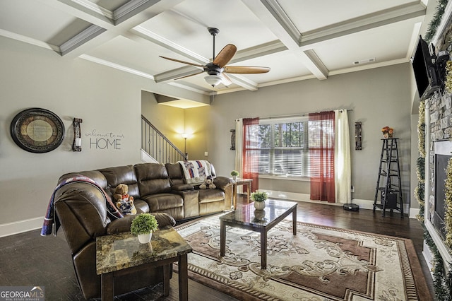 living room with coffered ceiling, crown molding, ceiling fan, beam ceiling, and dark hardwood / wood-style flooring