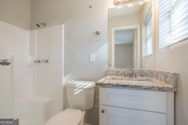 bathroom with vanity, toilet, and walk in shower