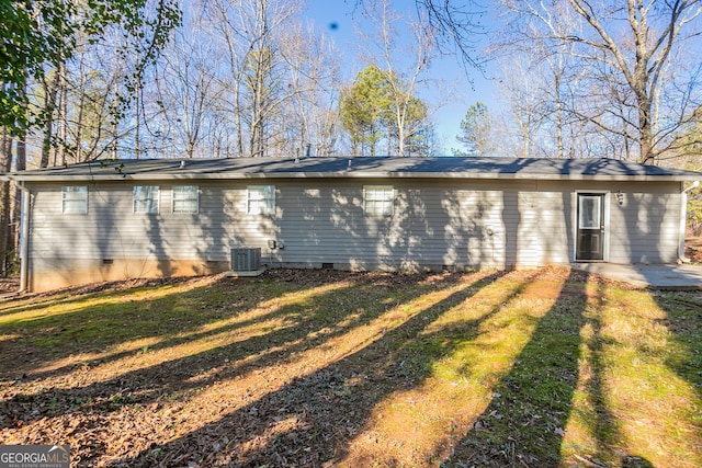 rear view of house featuring a lawn, a patio area, and central air condition unit