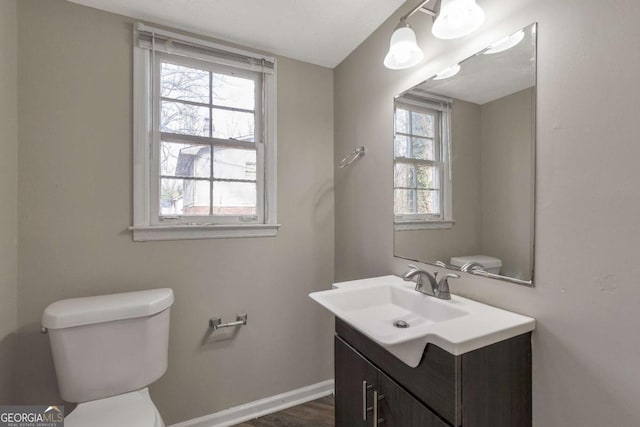 bathroom featuring hardwood / wood-style floors, vanity, and toilet