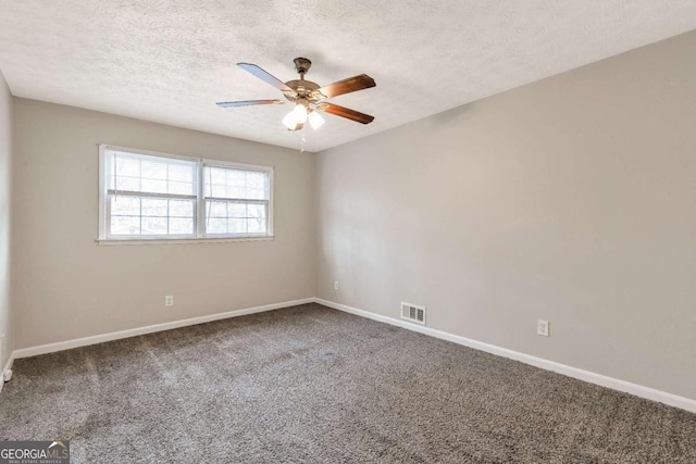 spare room with ceiling fan, carpet floors, and a textured ceiling