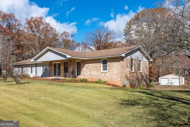 view of front facade with an outbuilding, a front lawn, and a garage