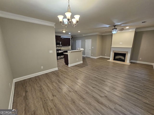 unfurnished living room with ceiling fan with notable chandelier, dark hardwood / wood-style floors, and ornamental molding