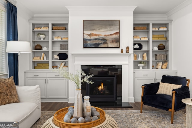 living area featuring dark hardwood / wood-style flooring and ornamental molding