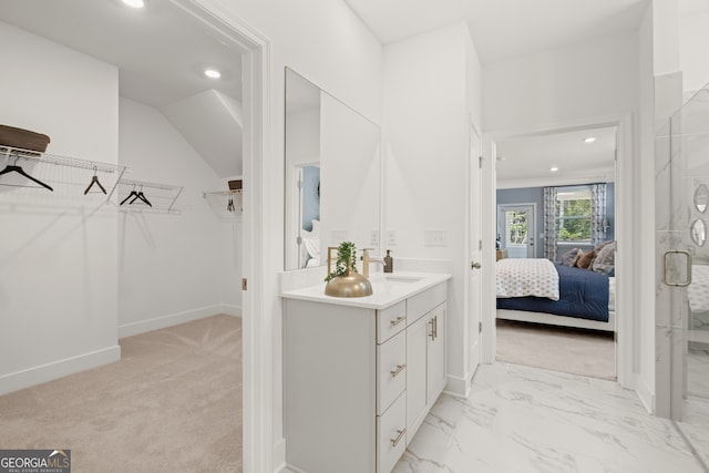 bathroom featuring vanity and a shower with shower door