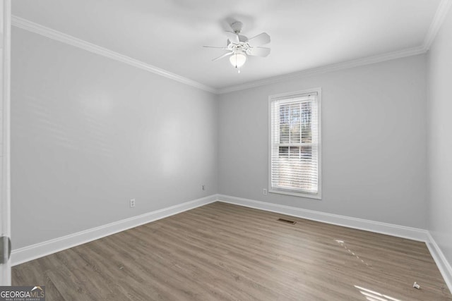 unfurnished room with ceiling fan, hardwood / wood-style floors, and crown molding