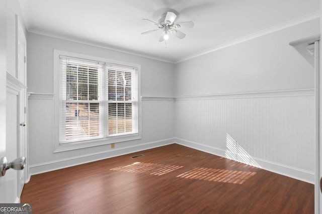 unfurnished room with ceiling fan, dark hardwood / wood-style flooring, and ornamental molding