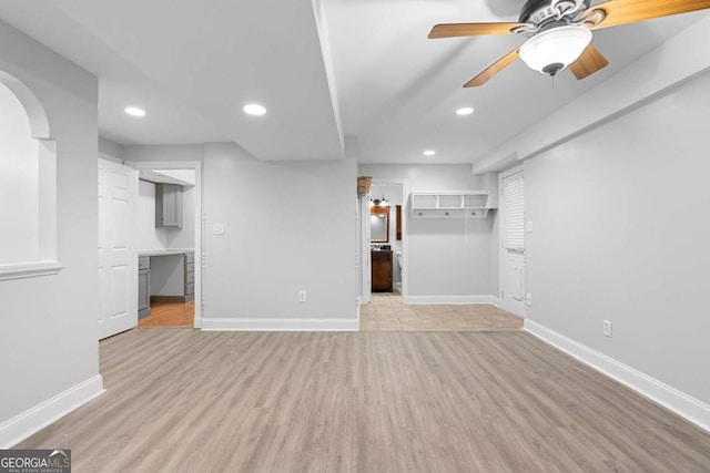 unfurnished living room with light hardwood / wood-style flooring and ceiling fan