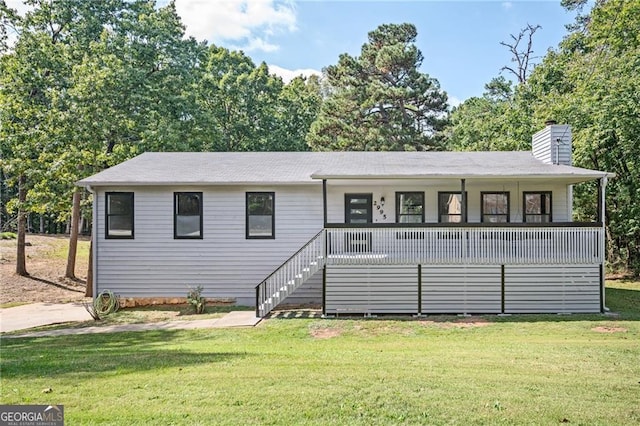 view of front facade with covered porch and a front lawn