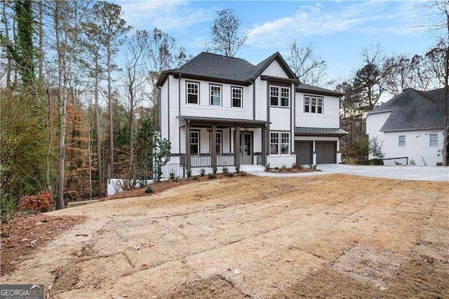 front of property with a garage and covered porch