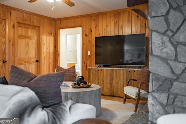 living room with ceiling fan and ornamental molding