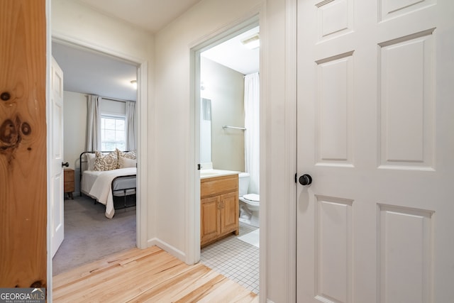 hallway with light hardwood / wood-style floors