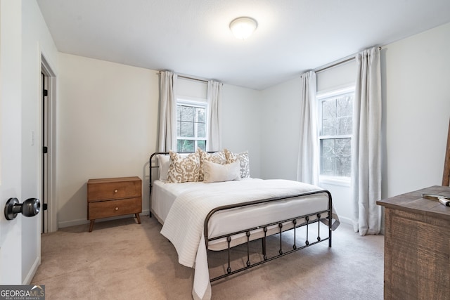 bedroom featuring light carpet