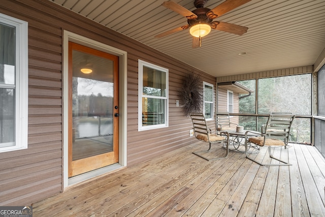 wooden terrace featuring ceiling fan