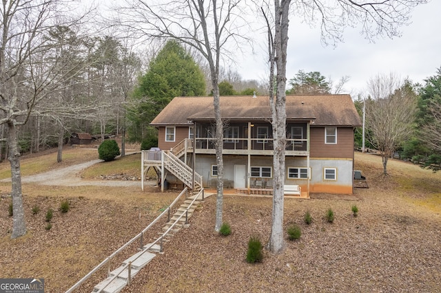 back of property with a wooden deck