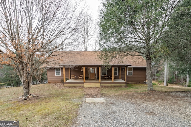 single story home with covered porch and a front lawn