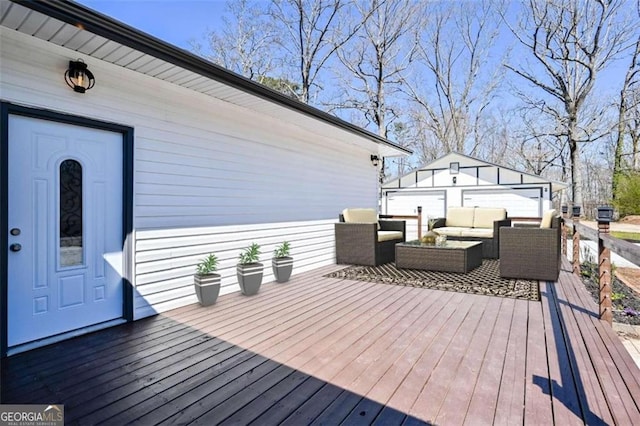 wooden terrace featuring outdoor lounge area, a garage, and an outdoor structure