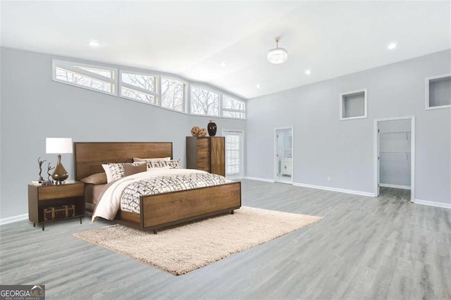 bedroom with light hardwood / wood-style flooring and vaulted ceiling