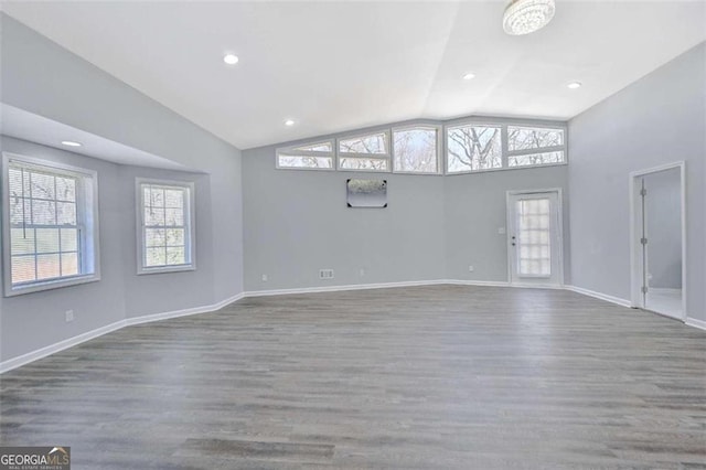 interior space featuring hardwood / wood-style floors and lofted ceiling