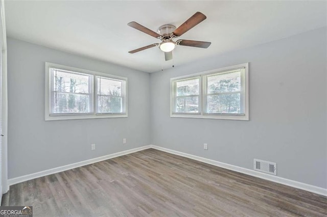 spare room featuring hardwood / wood-style floors, plenty of natural light, and ceiling fan