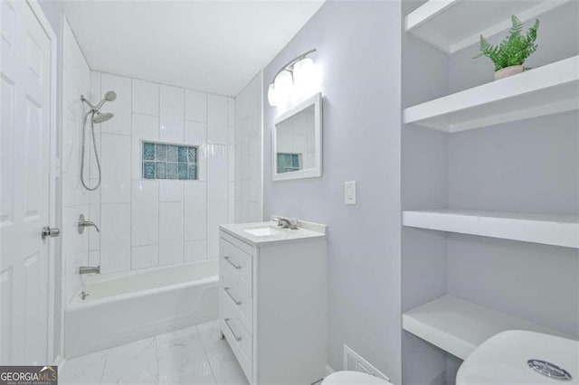 full bathroom with vanity, toilet, and tiled shower / bath combo