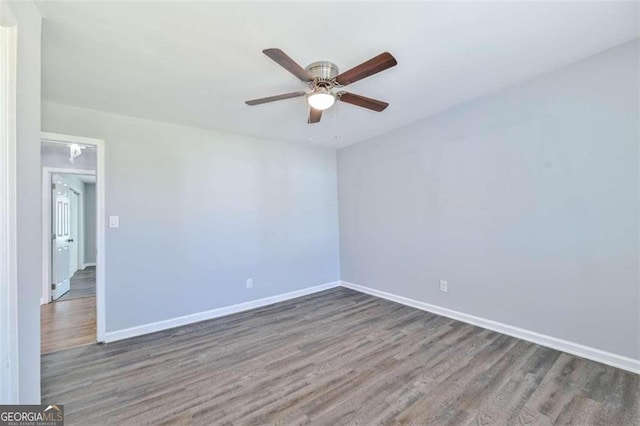 unfurnished room featuring dark hardwood / wood-style flooring and ceiling fan