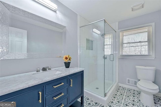 bathroom featuring walk in shower, vanity, and toilet