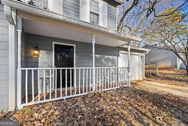 view of home's exterior featuring a porch and a garage