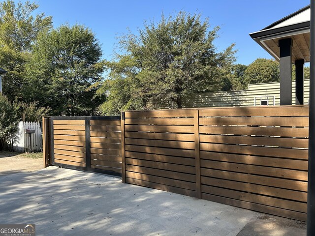 view of gate featuring a patio