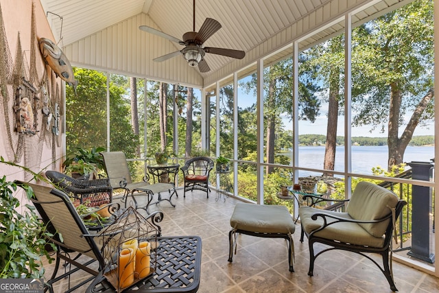 sunroom with ceiling fan, lofted ceiling, and a water view