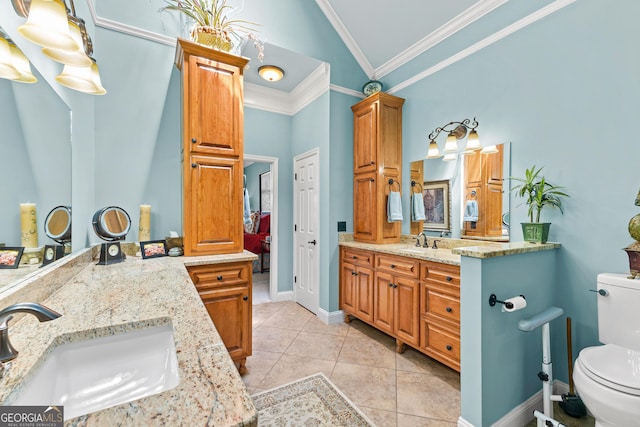 bathroom featuring toilet, vanity, vaulted ceiling, tile patterned floors, and ornamental molding