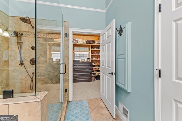 bathroom featuring an enclosed shower, tile patterned flooring, and crown molding